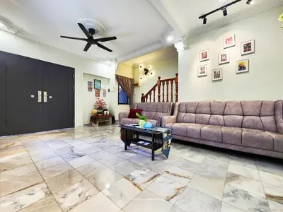 a living room with a couch and a ceiling fan at Ipoh 168 Taman Pelangi, Persiaran Halaman Ampang Ipoh Homestay in Ipoh