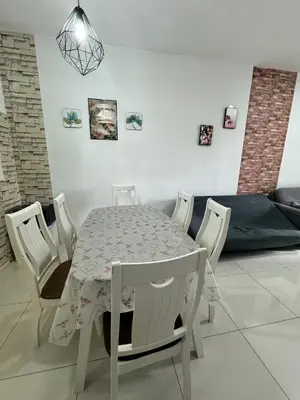 a white table and chairs in a living room at AYAAN BLOSSOM BUDGET HOMESTAY FREE WiFi and Netflix in Tanah Rata