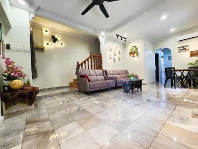 a living room with a couch and a table at IPOH Taman Pelangi Double Storey Homestay in Ipoh