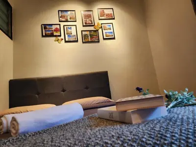 a bedroom with a bed with a book on the floor at IPOH Taman Pelangi Double Storey Homestay in Ipoh