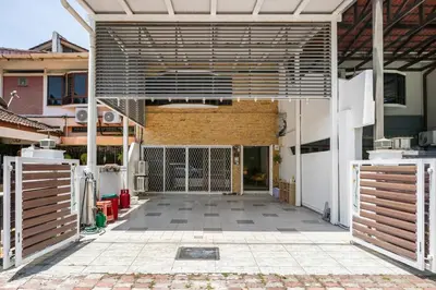 an open patio with a gate and a building at Riverview Staycation 5mins to Sunway Carnival for 9 pax in Perai