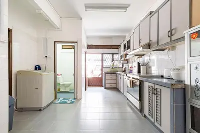 a large kitchen with white appliances and a hallway at Riverview Staycation 5mins to Sunway Carnival for 9 pax in Perai