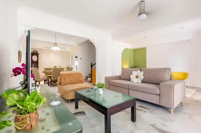 a living room with a couch and a table at Riverview Staycation 5mins to Sunway Carnival for 9 pax in Perai
