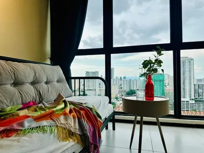 a room with a couch and a table and a window at 3BR apartments 10pax george town netflix in Jelutong