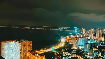a view of a city at night with a bridge at 3BR apartments 10pax george town netflix in Jelutong