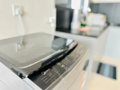 a cell phone sitting on top of a shelf at 3BR apartments 10pax george town netflix in Jelutong