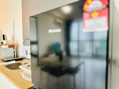 a blurry picture of a kitchen with a refrigerator at 3BR apartments 10pax george town netflix in Jelutong
