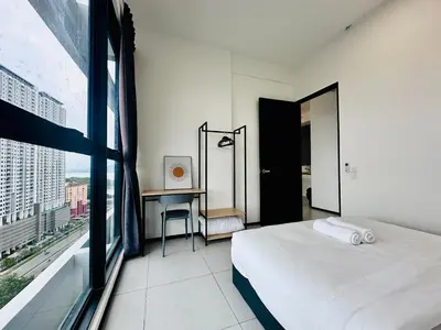 a bedroom with a bed and a desk and a window at 3BR apartments 10pax george town netflix in Jelutong