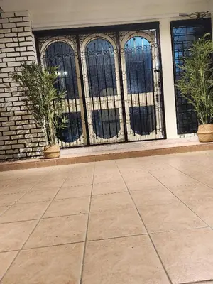a building with barred windows and potted plants at Sun Rock Home by Ipoh Maju Stay in Ipoh