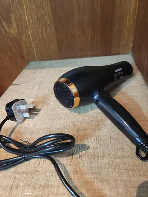 a blow dryer on a wooden table with a microphone at Sun Rock Home by Ipoh Maju Stay in Ipoh