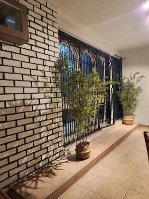 a room with two potted plants and a brick wall at Sun Rock Home by Ipoh Maju Stay in Ipoh