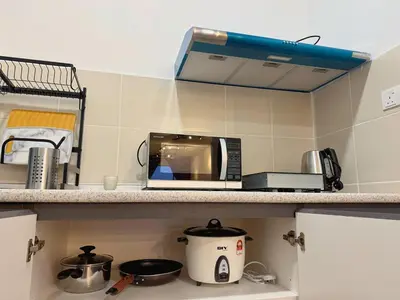 a kitchen with a toaster and a microwave on a shelf at 180view TopHill Keafarm 7-9Pax #Cool Summer Cameron in Brinchang