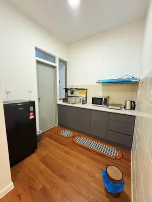 a kitchen with a black refrigerator and a wooden floor at 180view TopHill Keafarm 7-9Pax #Cool Summer Cameron in Brinchang