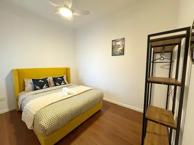 a bedroom with a bed and a wooden floor at 180view TopHill Keafarm 7-9Pax #Cool Summer Cameron in Brinchang