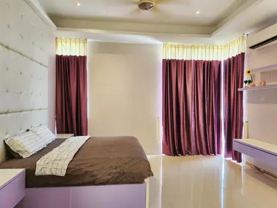 a bedroom with a bed with red curtains at Botani Nadya 5B4B by verve 19 pax in Ipoh