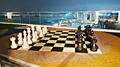 a chess board on a table with a view of a city at relax family stay 3BR 10pax urban in Jelutong