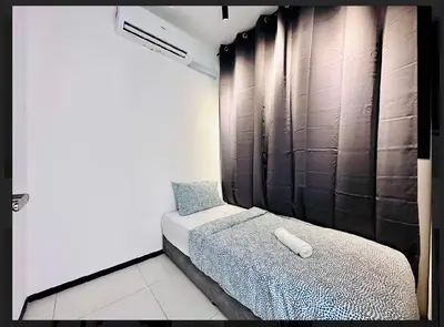a small bedroom with a bed and a wall at relax family stay 3BR 10pax urban in Jelutong