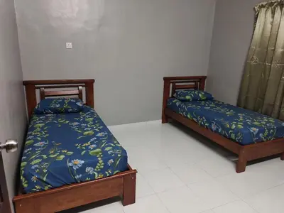 two beds sitting in a room with at DeStay Taiping in Taiping
