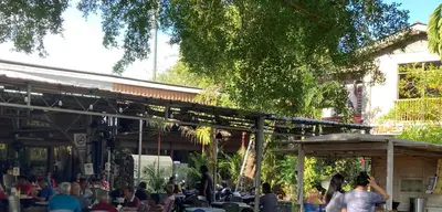 a crowd of people sitting outside of a building at De Village Lodge in Balik Pulau