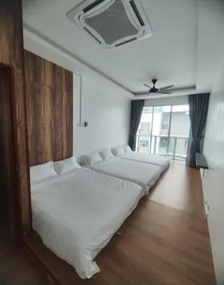 a row of beds in a room with a window at Sekinchan SeaView Garden 20pax 6R6B HighView in Sekincan
