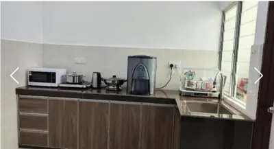 a kitchen with a counter top with a microwave at Sekinchan SeaView Garden 20pax 6R6B HighView in Sekincan