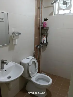 a bathroom with a toilet and a sink at Sekinchan SeaView Garden 20pax 6R6B HighView in Sekincan