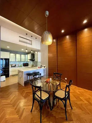 a kitchen and dining room with a glass table and chairs at Marina Suite with Seafront Sunrise View in George Town
