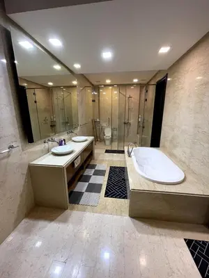a bathroom with two sinks and a tub and a shower at Marina Suite with Seafront Sunrise View in George Town