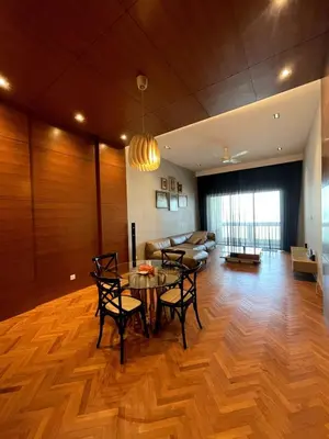 a living room with a table and chairs and a couch at Marina Suite with Seafront Sunrise View in George Town