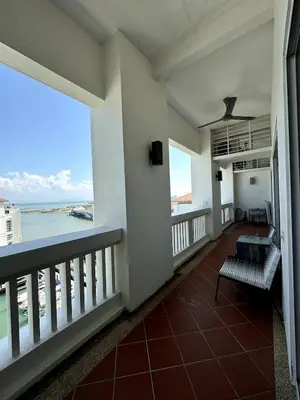 a balcony with a view of the ocean at Marina Suite with Seafront Sunrise View in George Town