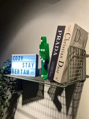 a wire rack with books and books on it at Cozy Stay Bertam in Kepala Batas