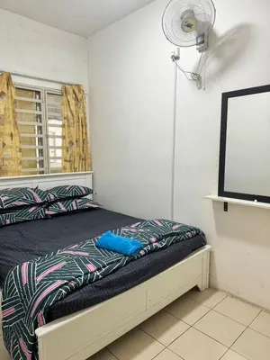a bedroom with a bed and a fan at AYAAN BLOOM BUDGET HOMESTAY FREE WiFi & Netflix in Cameron Highlands