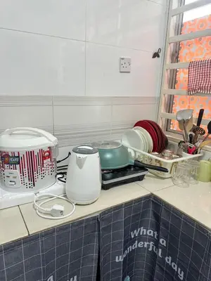 a kitchen counter with some dishes and a sink at AYAAN BLOOM BUDGET HOMESTAY FREE WiFi & Netflix in Cameron Highlands
