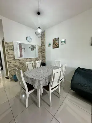 a dining room with a table and white chairs at AYAAN BLOOM BUDGET HOMESTAY FREE WiFi & Netflix in Cameron Highlands
