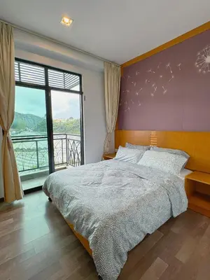 a bedroom with a large bed and a large window at Sunrise & KeaFarmview at Hilltop NOVA CoolSummer in Tanah Rata
