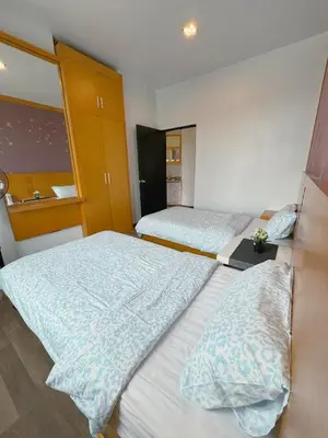a bedroom with two beds and a mirror at Sunrise & KeaFarmview at Hilltop NOVA CoolSummer in Tanah Rata
