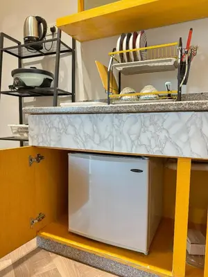 a kitchen with a counter top with a white appliance at Sunrise & KeaFarmview at Hilltop NOVA CoolSummer in Tanah Rata