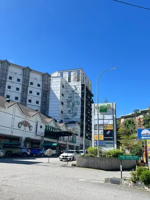 a parking lot with cars parked in front of buildings at Nova Highlands Hilltop Retreat Cameron Highlands in Brinchang