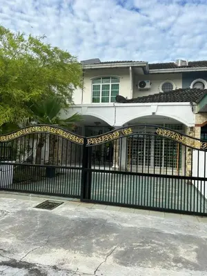 a black iron gate in front of a house at Double Storey Terrace House in Perai