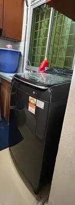 a washing machine sitting on the floor in a room at Double Storey Terrace House in Perai