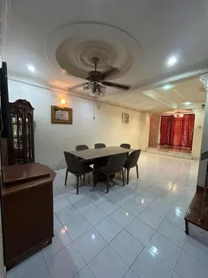 a dining room with a table and chairs and a ceiling at Double Storey Terrace House in Perai