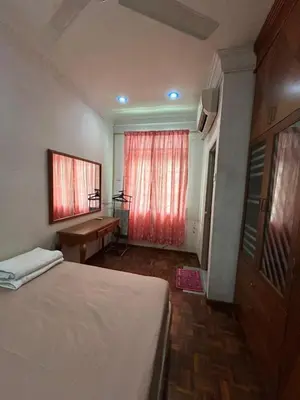 a bedroom with a bed and a desk and a window at Double Storey Terrace House in Perai