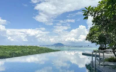 a swimming pool with a view of a body of water at Panoramic Georgetown City & Sea View with Netflix in Jelutong