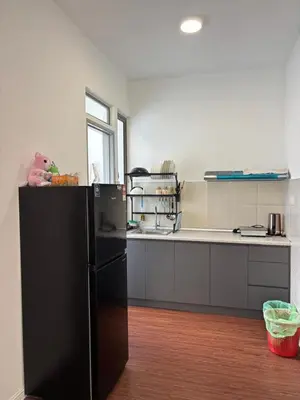 a kitchen with a black refrigerator in a room at Ella Residence Homestay 2 in Brinchang
