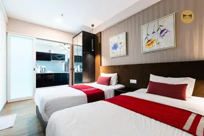 a hotel room with two beds with red and white sheets at Seaview Seafront Duplex in Town with WiFi & Full Kitchen 23 in George Town