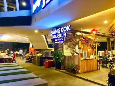 a restaurant in a shopping mall with people sitting at tables at Seaview Seafront Duplex in Town with WiFi & Full Kitchen 23 in George Town