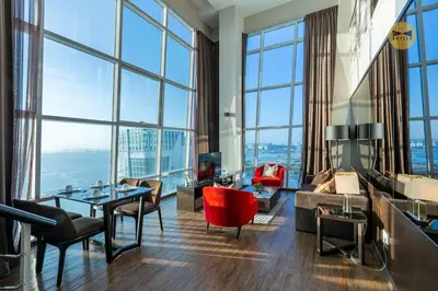 a living room with a view of the city at Seaview Seafront Duplex in Town with WiFi & Full Kitchen 23 in George Town