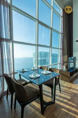 a dining room with a table and chairs and a large window at Seaview Seafront Duplex in Town with WiFi & Full Kitchen 23 in George Town