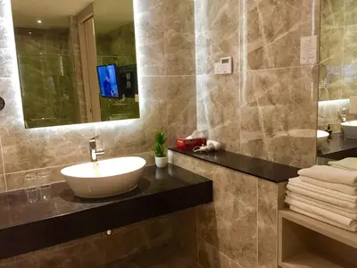 a bathroom with a sink and a mirror at Big BathTub Premium Seafront Studio in Town with WiFi & Full Kitchen in George Town