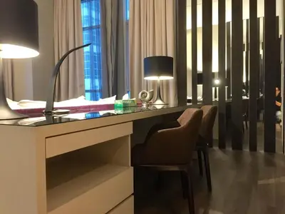 a bedroom with a desk with a chair and a lamp at Big BathTub Premium Seafront Studio in Town with WiFi & Full Kitchen in George Town